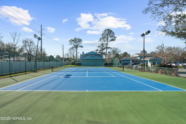 view of sport court featuring fence