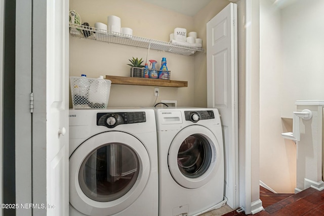 laundry area with hardwood / wood-style floors and washing machine and clothes dryer