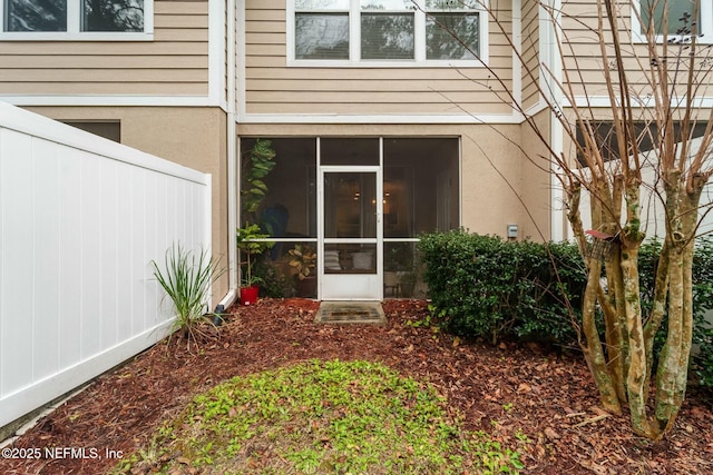 rear view of property with a sunroom