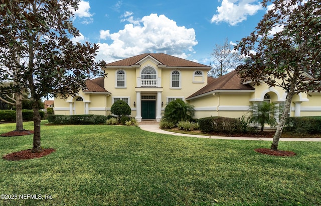 mediterranean / spanish-style house featuring a front yard