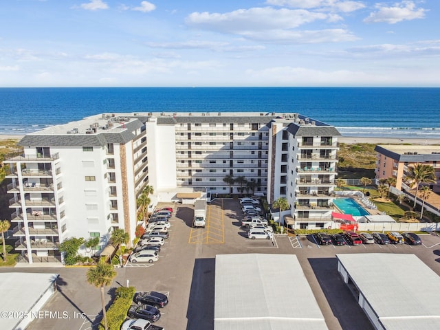 aerial view with a water view and a view of the beach