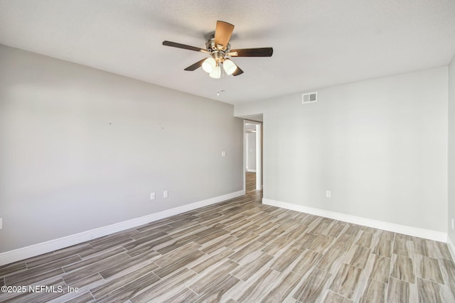 spare room with ceiling fan and light hardwood / wood-style floors