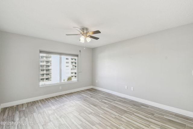 spare room featuring ceiling fan and light hardwood / wood-style flooring