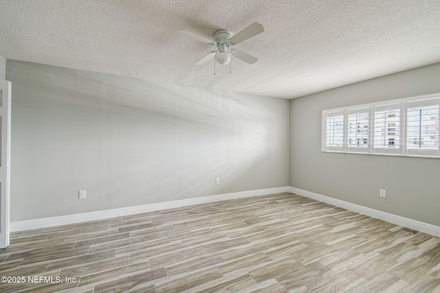 empty room featuring ceiling fan, a textured ceiling, and light hardwood / wood-style flooring