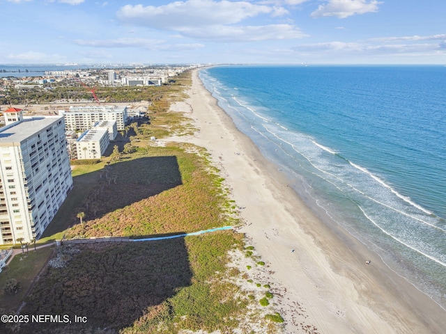 bird's eye view featuring a water view and a view of the beach