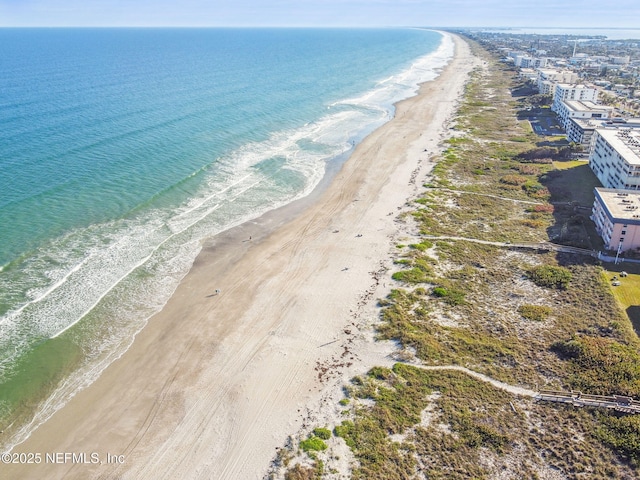 bird's eye view featuring a view of the beach and a water view