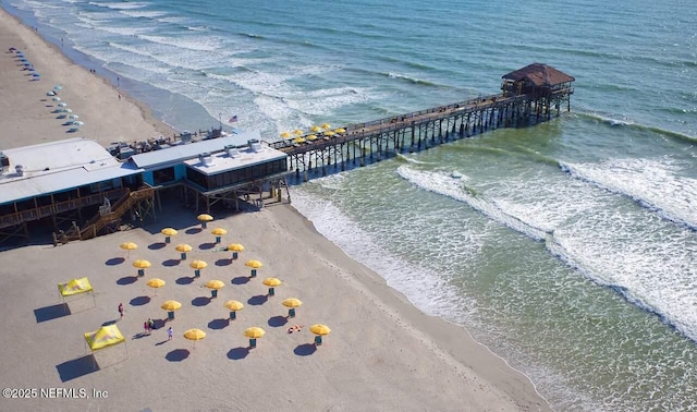 drone / aerial view featuring a water view and a view of the beach