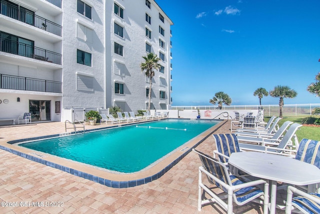 view of swimming pool featuring a patio