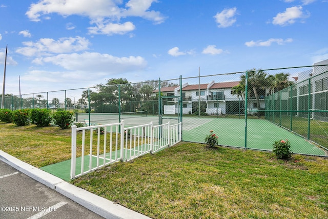 view of sport court featuring a yard