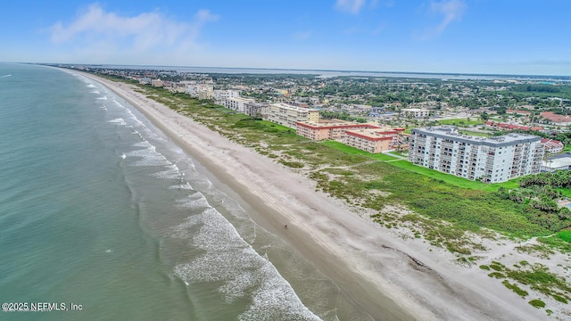 birds eye view of property featuring a beach view and a water view