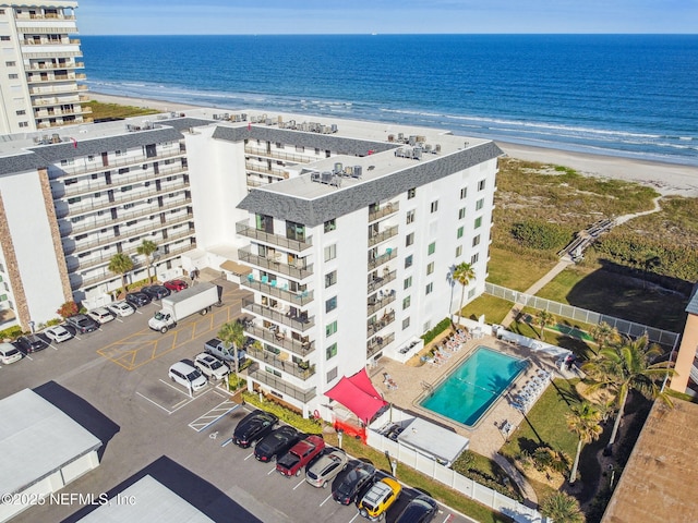 birds eye view of property featuring a water view and a beach view