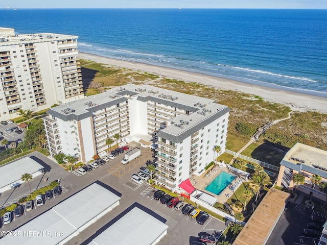 bird's eye view featuring a water view and a view of the beach