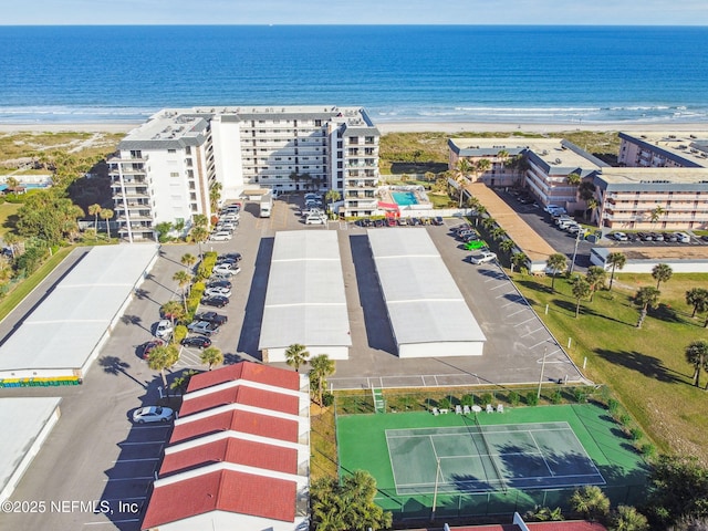 bird's eye view with a water view and a beach view