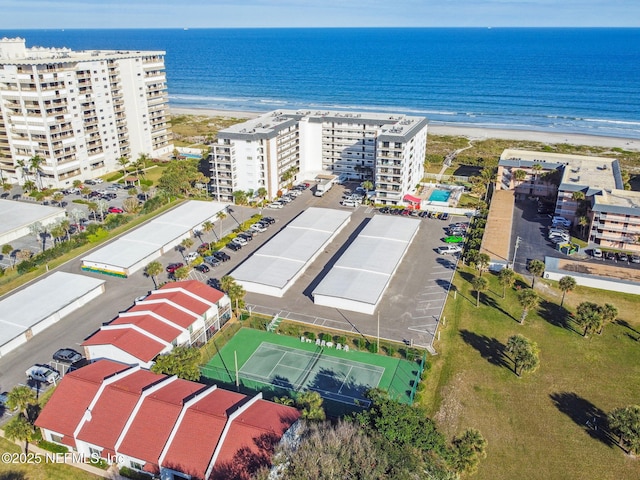 aerial view with a water view and a beach view