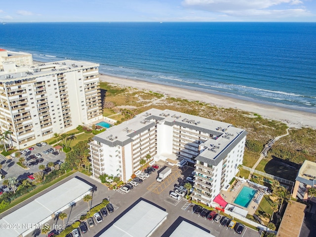 drone / aerial view featuring a water view and a beach view