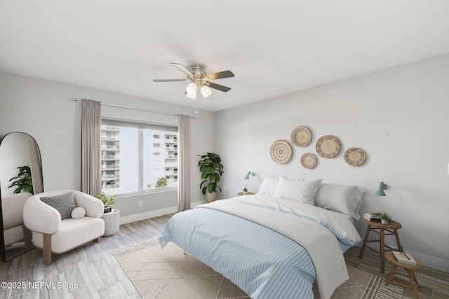 bedroom with ceiling fan and light wood-type flooring