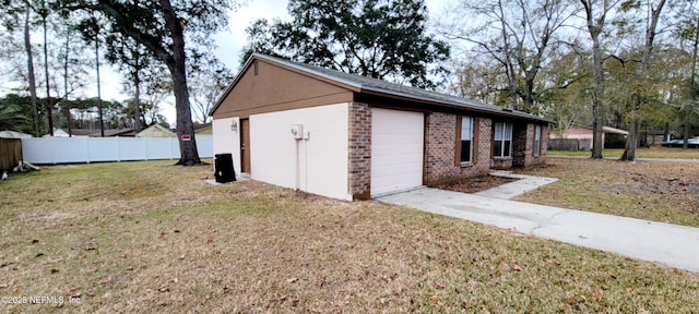 view of side of home with a garage and a lawn