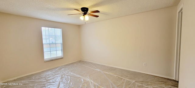 spare room featuring a textured ceiling and ceiling fan