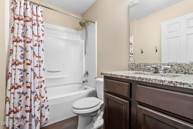 full bathroom featuring toilet, vanity, and shower / bath combo with shower curtain