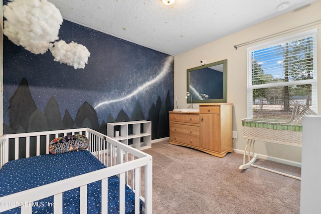 carpeted bedroom featuring a textured ceiling