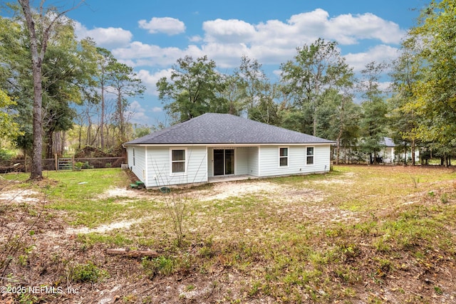 rear view of property with a yard