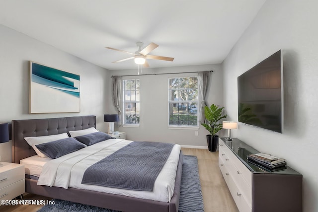 bedroom with ceiling fan and light hardwood / wood-style floors