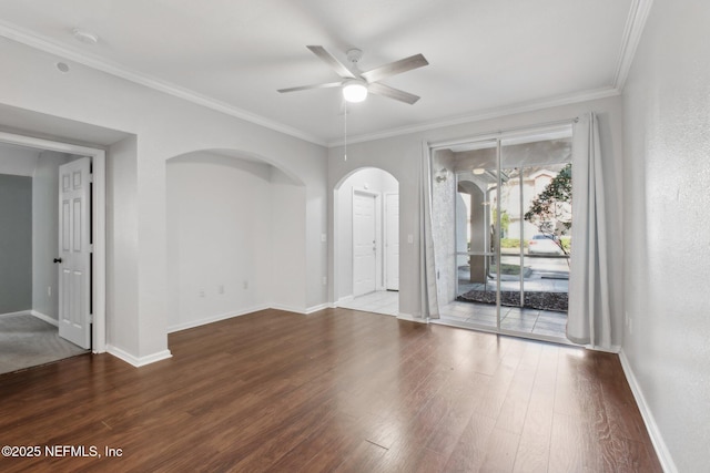 spare room featuring ceiling fan, dark hardwood / wood-style flooring, and ornamental molding