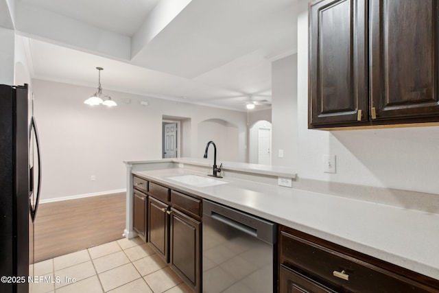 kitchen with black refrigerator, dishwashing machine, light tile patterned flooring, crown molding, and sink