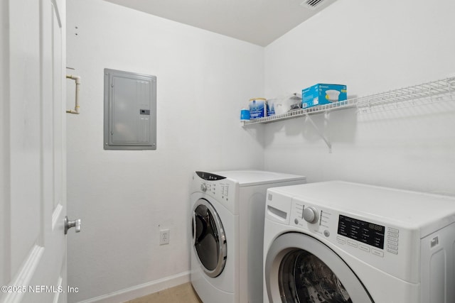 clothes washing area featuring electric panel and washer and dryer