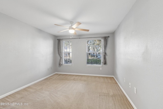 empty room with light carpet and ceiling fan