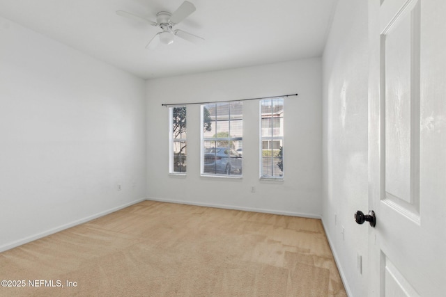 empty room featuring light carpet and ceiling fan