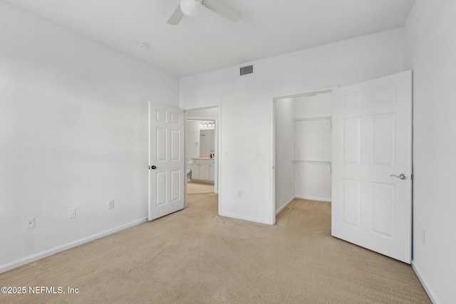 unfurnished bedroom with ceiling fan, light colored carpet, and a closet