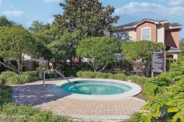 view of pool with a hot tub