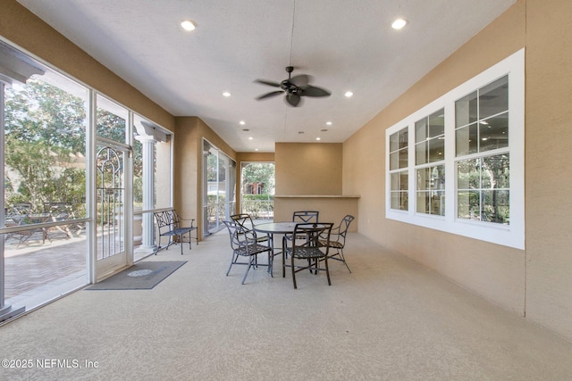 sunroom featuring ceiling fan and a healthy amount of sunlight