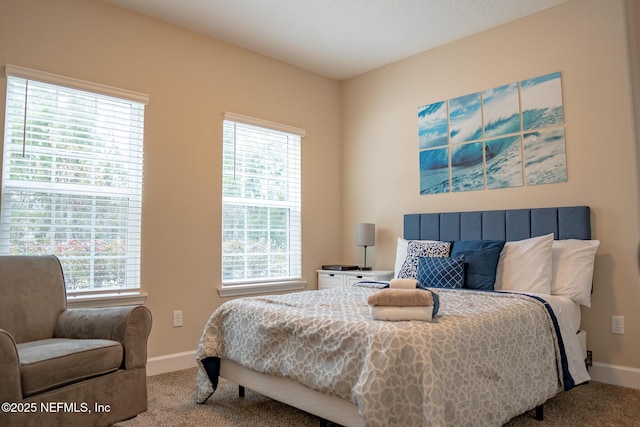 bedroom with multiple windows and carpet