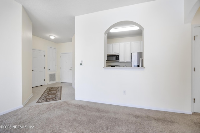 unfurnished living room with light carpet