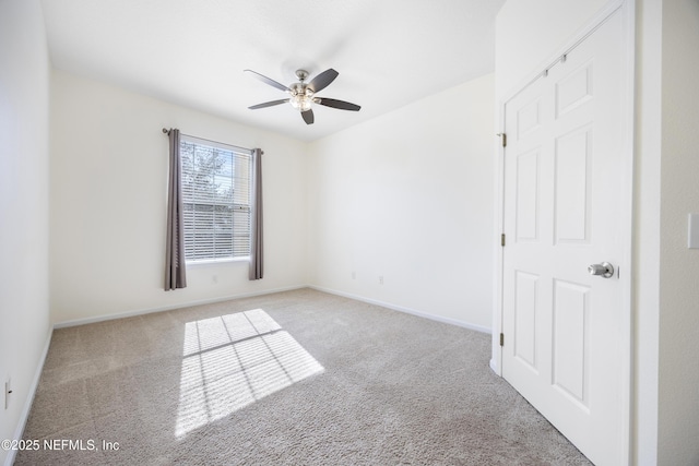 carpeted spare room with ceiling fan