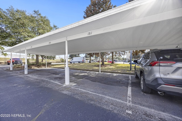 view of vehicle parking with a carport