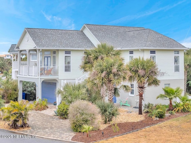 view of front of home featuring a garage and a balcony