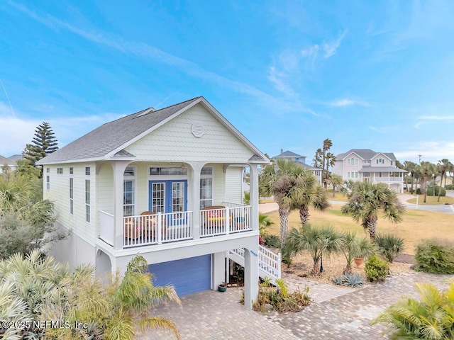 view of front of property with a porch and a garage