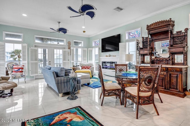 dining room featuring ornamental molding, light tile patterned floors, ceiling fan, and french doors