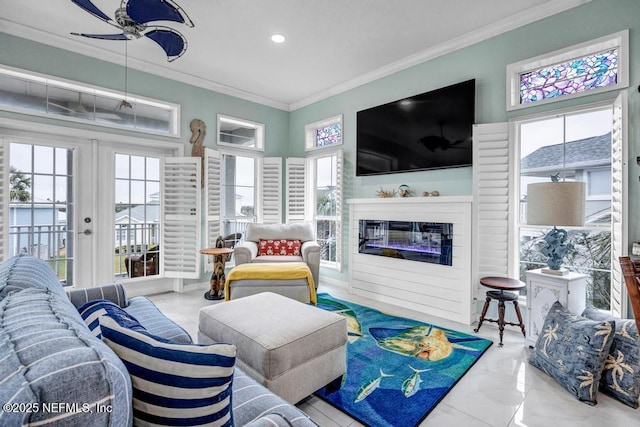 living room featuring ornamental molding, plenty of natural light, ceiling fan, and french doors