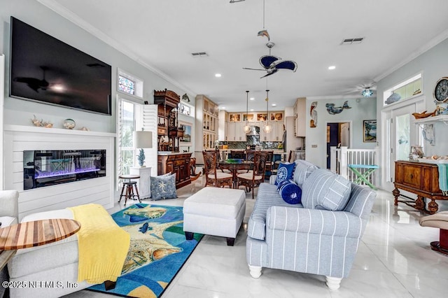 living room featuring ceiling fan and ornamental molding