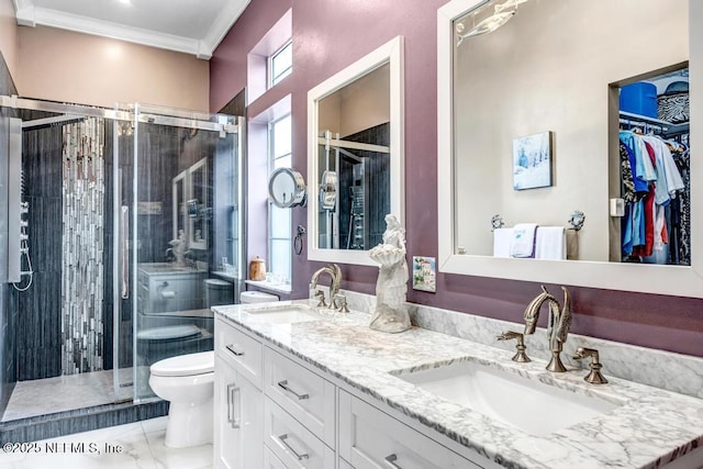 bathroom featuring vanity, ornamental molding, an enclosed shower, and toilet