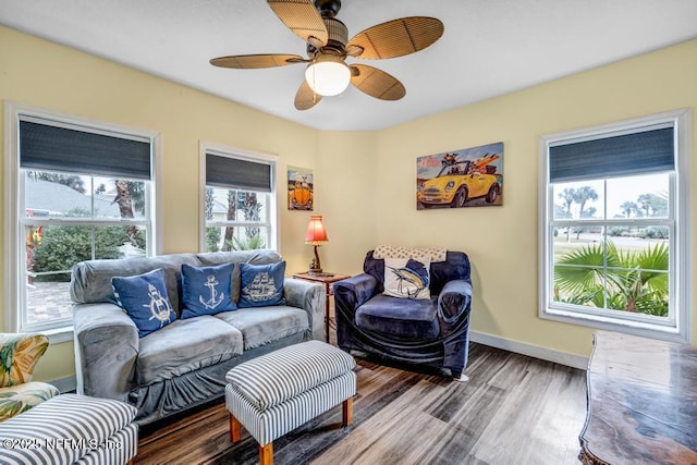 living room featuring ceiling fan and hardwood / wood-style floors