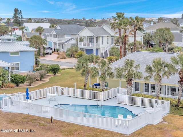 view of pool with a patio and a yard