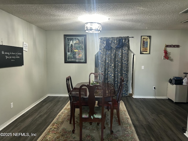 dining space featuring a textured ceiling and dark hardwood / wood-style flooring