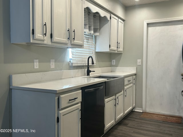 kitchen with white cabinetry, dishwasher, dark hardwood / wood-style floors, and sink