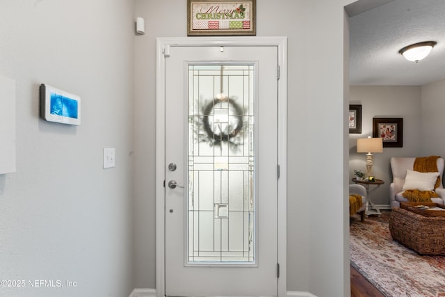 foyer with a textured ceiling