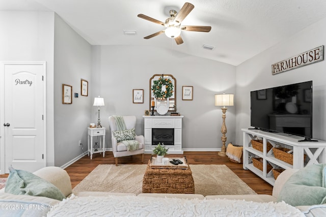 living room featuring ceiling fan, dark hardwood / wood-style flooring, and lofted ceiling